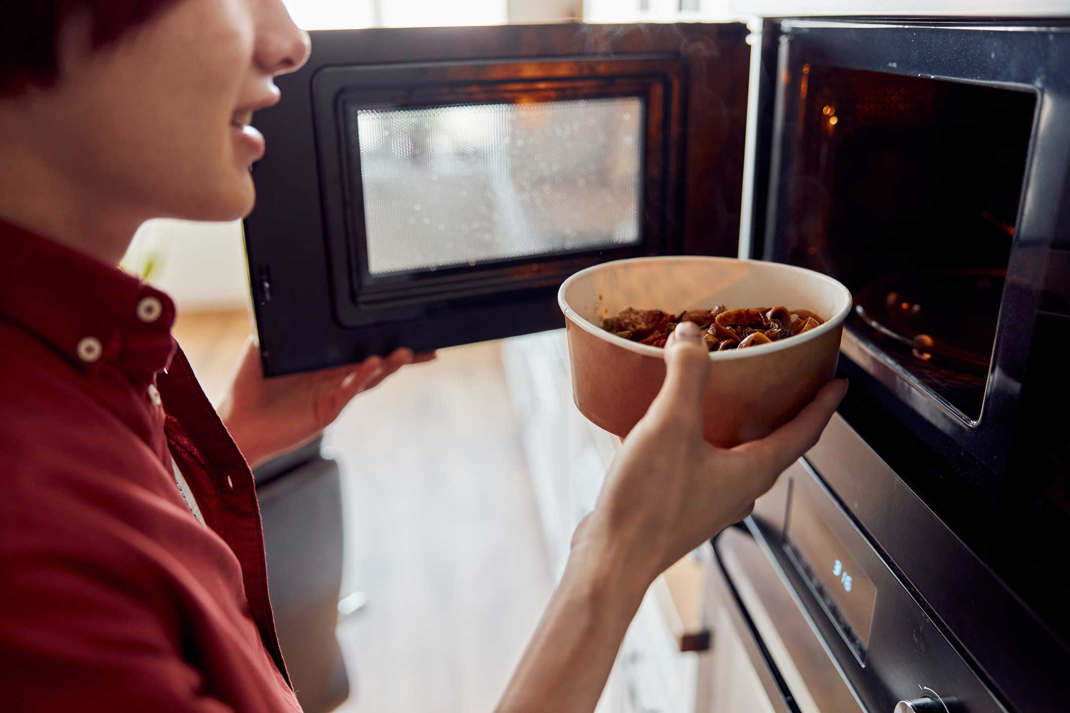 person microwaving food